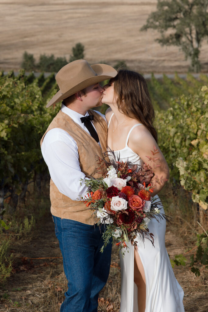 Bride and groom kissing during golden hour couples portraits