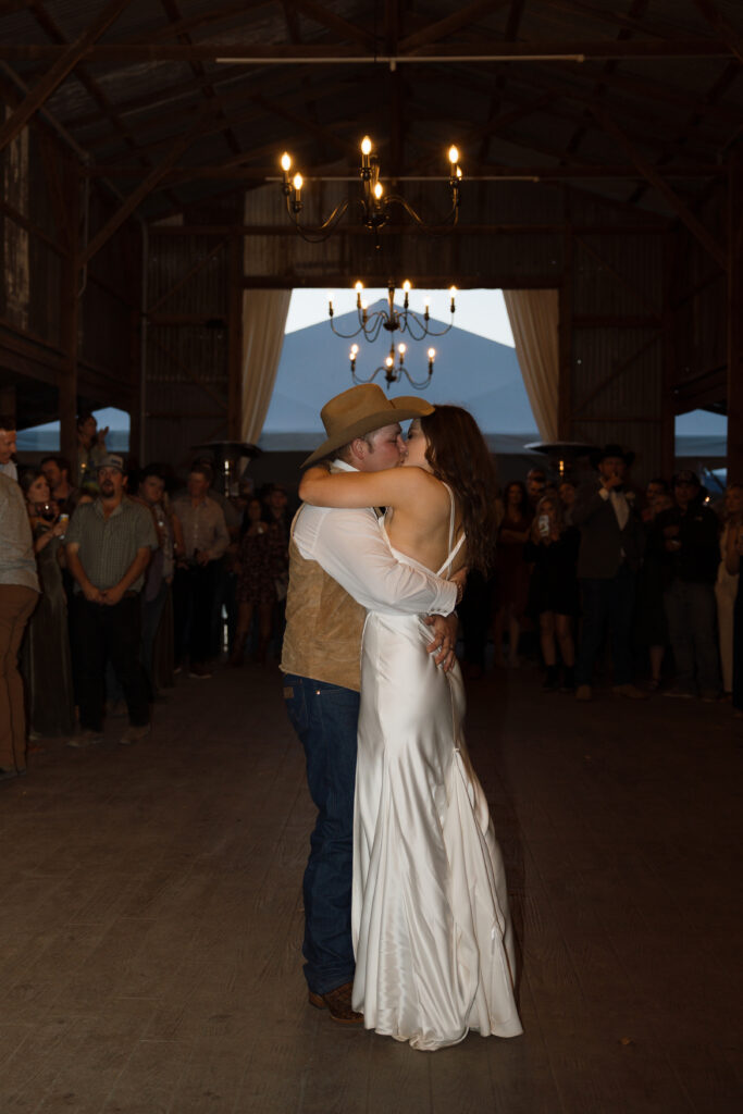 Bride and groom share first kiss on dancefloor
