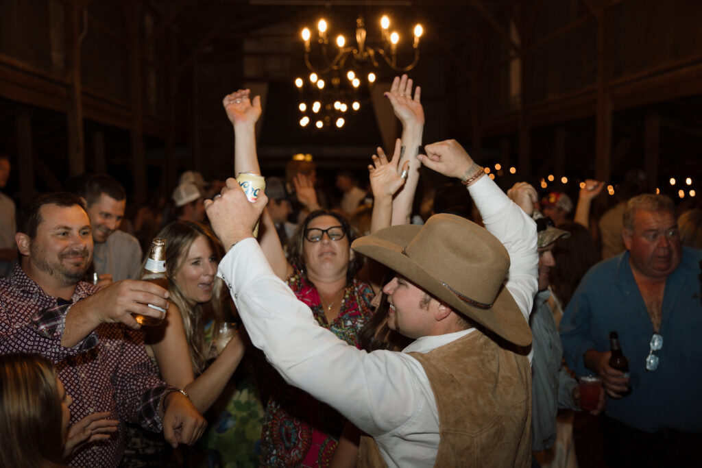 Groom celebrates on the dance floor at his wedding